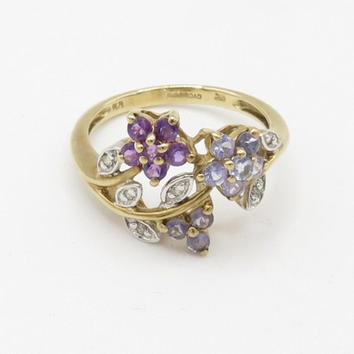 109 - 9ct gold tanzanite, diamond, and amethyst set floral garland ring (2.3g) Size  L