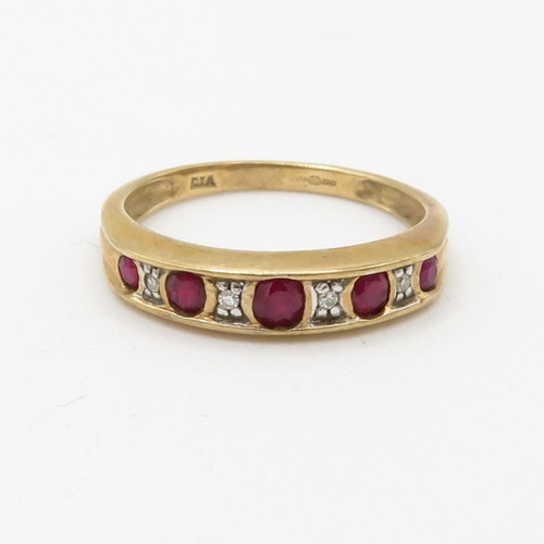 78 - 9ct gold diamond and ruby set nine stone eternity ring (2g) Size  N