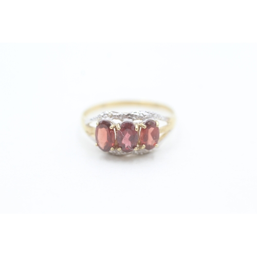 3 - 9ct gold diamond accented garnet trilogy ring (1.4g) Size O