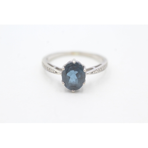 49 - 9ct gold oval cut blue topaz & diamond dress ring (2.7g) Size Q 1/2