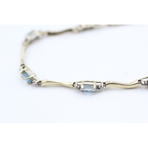 9 - 10kt gold blue topaz set station bracelet (3.8g)