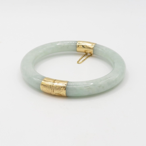 84 - 14ct gold jade bangle (48.2g)