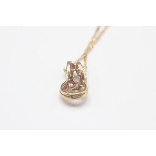 37 - 9ct gold ruby twist pendant on chain (4.1g)