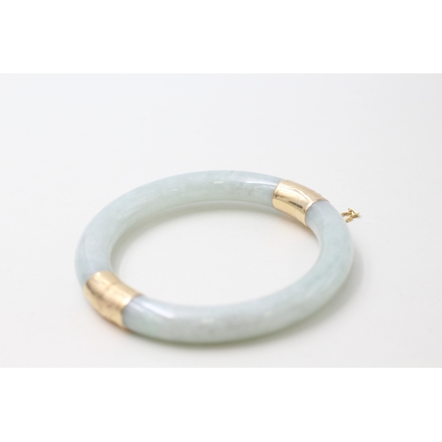 84 - 14ct gold jade bangle (48.2g)