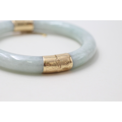 84 - 14ct gold jade bangle (48.2g)