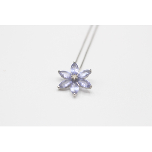 96 - 9ct white gold tanzanite and diamond floral pendant on chain (1.4g)