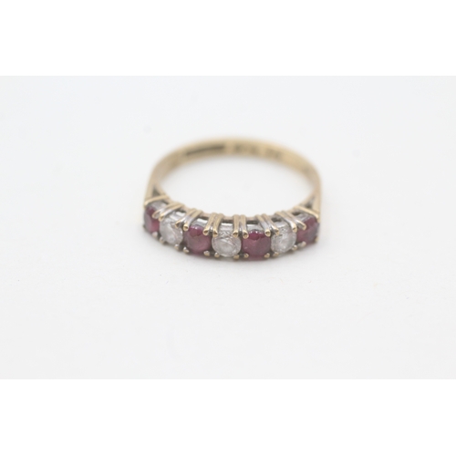 121 - 9ct gold ruby & cubic zirconia half eternity ring (1.8g) Size L