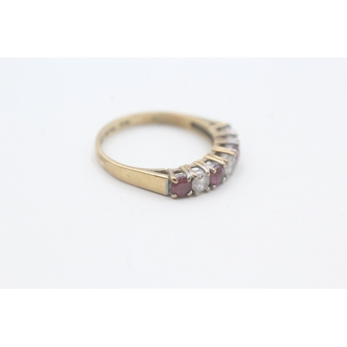 121 - 9ct gold ruby & cubic zirconia half eternity ring (1.8g) Size L