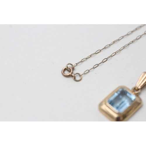 165 - 9ct gold blue topaz pendant necklace (2.2g)