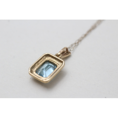 165 - 9ct gold blue topaz pendant necklace (2.2g)