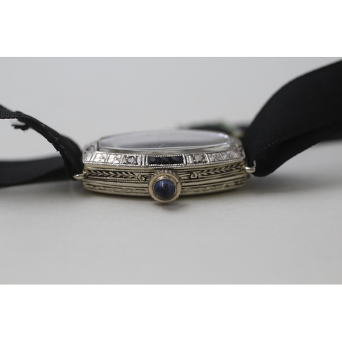 182 - 18ct gold diamond and sapphire watch head on fabric strap (10g)