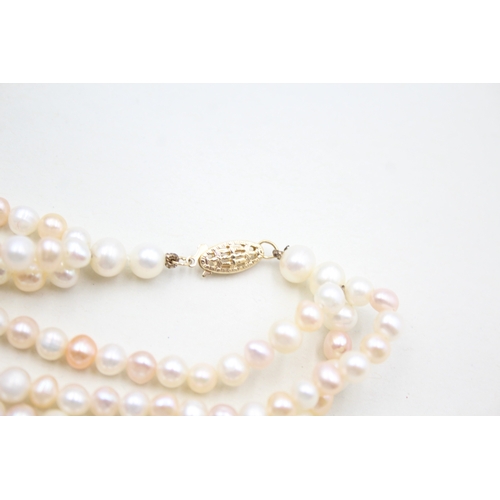 39 - 14ct gold pearl three strand necklace (78g)