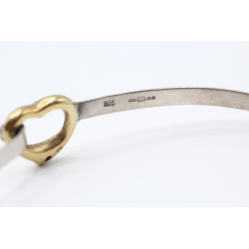 71 - 9ct gold & silver heart shape diamond bangle (9.2g)