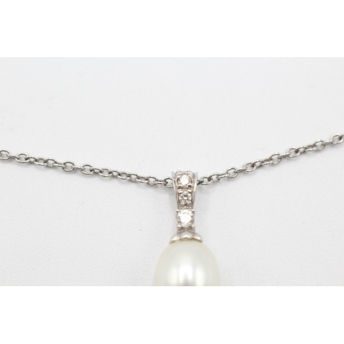 83 - 9ct gold diamond and cultured pearl pendant on chain (3.4g)