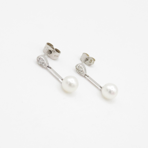 115 - 9ct white gold diamond and cultured pearl set drop earrings (1.8g)