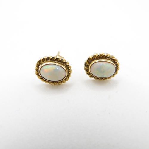 58 - 9ct gold opal stud earrings with scroll backs (1.3g)