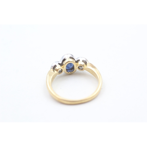 145 - 18ct gold synthetic sapphire & diamond three stone ring (4.1g) Size L