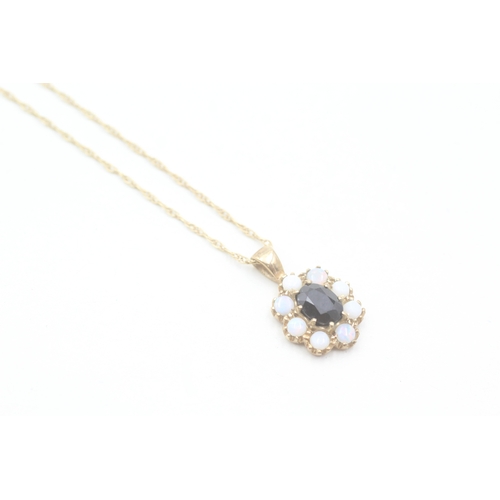 193 - 9ct gold sapphire and opal halo set pendant on chain (2.4g)