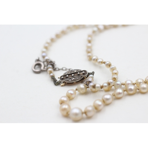 247 - 15ct gold & palladium antique pearl necklace with a diamond clasp (5.3g)