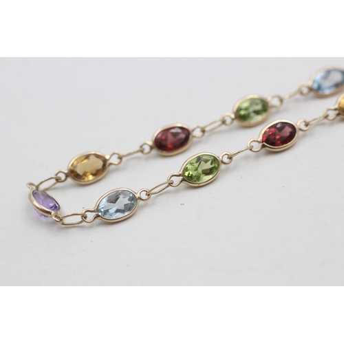 258 - 9ct gold garnet, amethyst, citrine, peridot and topaz bracelet (2.5g)