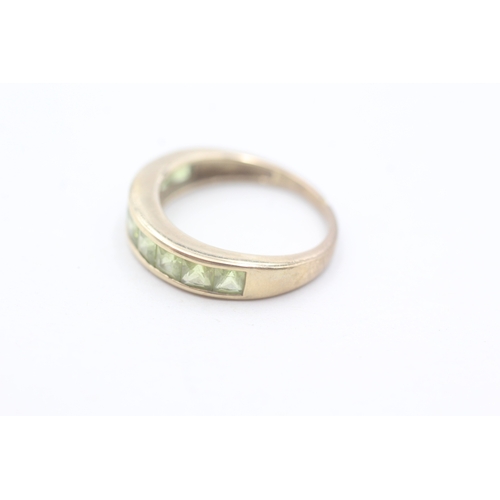 64 - 9ct gold and peridot channel set ring (2.2g) AS SEEN - MISSHAPEN Size L 1/2