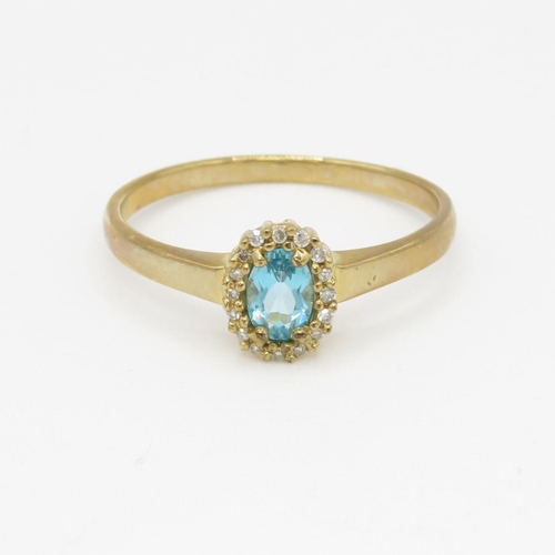 122 - 9ct gold blue gemstone and diamond halo set ring (2.4g) Size V