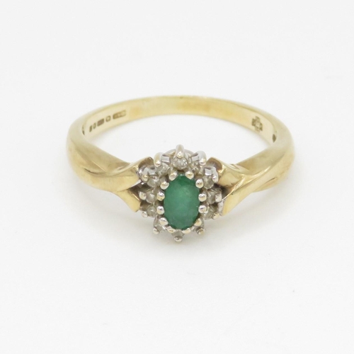 128 - 9ct gold emerald and diamond halo set ring (2.4g)