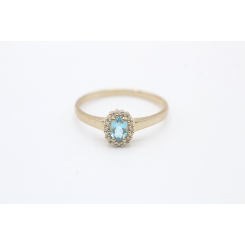 122 - 9ct gold blue gemstone and diamond halo set ring (2.4g) Size V