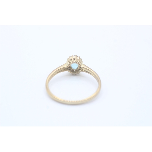 122 - 9ct gold blue gemstone and diamond halo set ring (2.4g) Size V