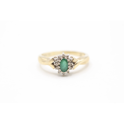 128 - 9ct gold emerald and diamond halo set ring (2.4g)