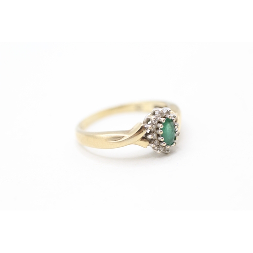 128 - 9ct gold emerald and diamond halo set ring (2.4g)