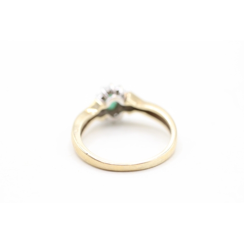 128 - 9ct gold emerald and diamond halo set ring (2.4g)