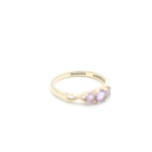 165 - 9ct gold amethyst three stone ring (1.9g) Size P