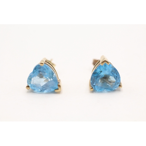 38 - 9ct gold heart cut blue topaz stud earrings (3.1g)