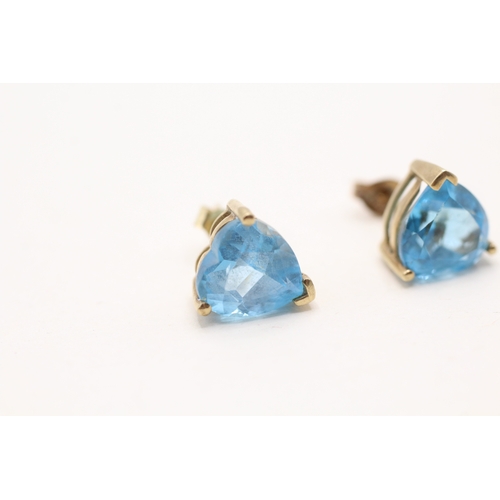 38 - 9ct gold heart cut blue topaz stud earrings (3.1g)