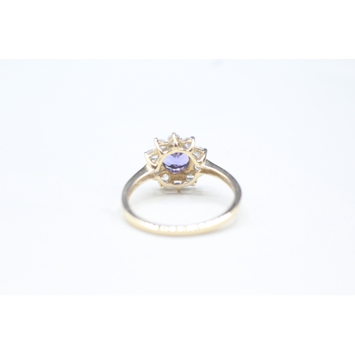 48 - 9ct gold tanzanite and white zircon halo set ring (2.2g) Size O