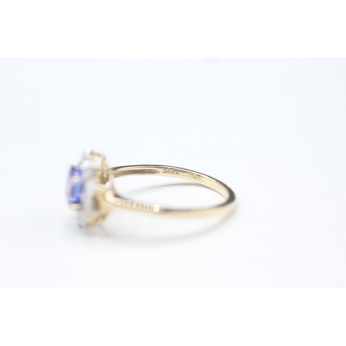 48 - 9ct gold tanzanite and white zircon halo set ring (2.2g) Size O