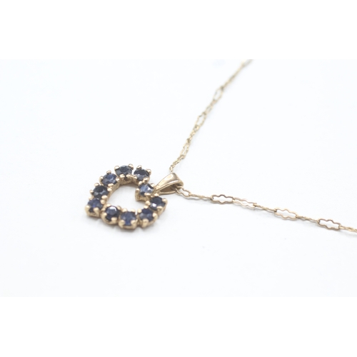 60 - 9ct gold and sapphire heart shaped pendant on chain (3.2g)