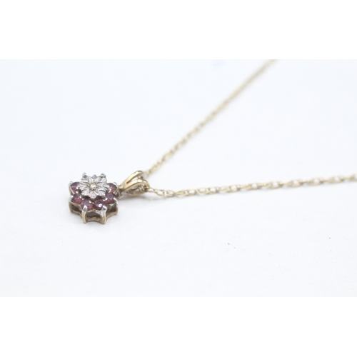 71 - 9ct gold diamond and ruby flower cluster pendant on chain (1.4g)