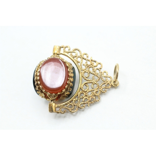 86 - 9ct gold onyx, blood stone and carnelian spinner fob (3.4g)