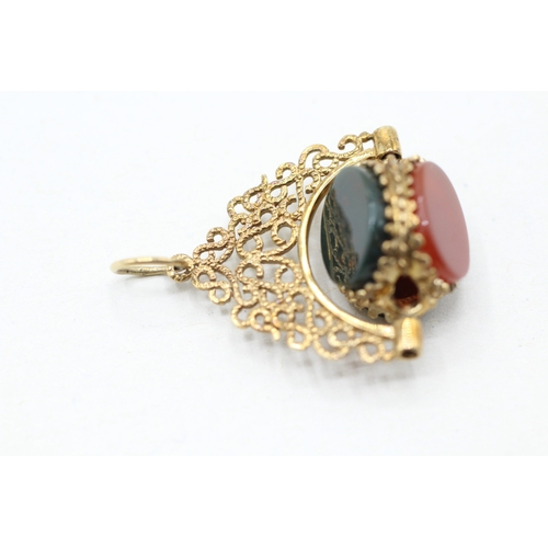 86 - 9ct gold onyx, blood stone and carnelian spinner fob (3.4g)