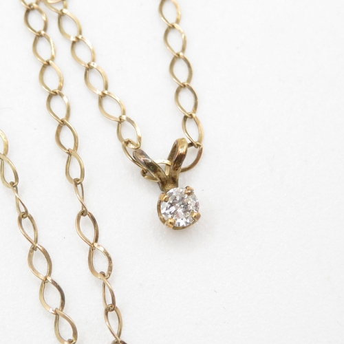 242 - 9ct gold single diamond pendant on chain (1.1g)