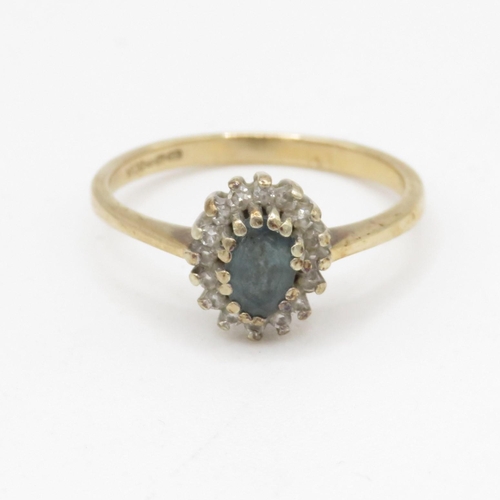 106 - 9ct gold blue topaz and diamond halo set ring (2.2g) Size P