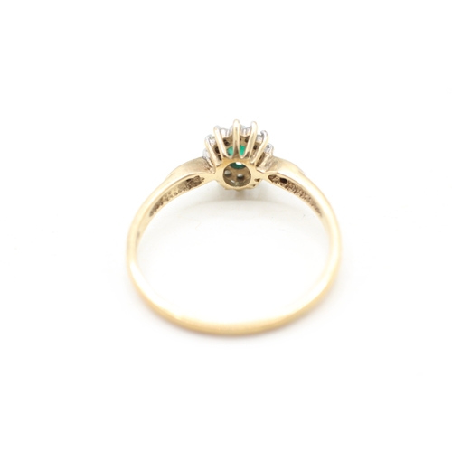 114 - 9ct gold emerald and diamond halo ring (1.8g) Size P