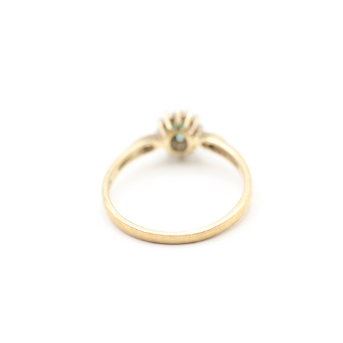 114 - 9ct gold emerald and diamond halo ring (1.8g) Size P