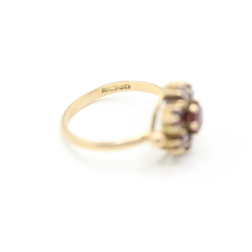 118 - 9ct gold garnet halo ring (2.9g) Size M