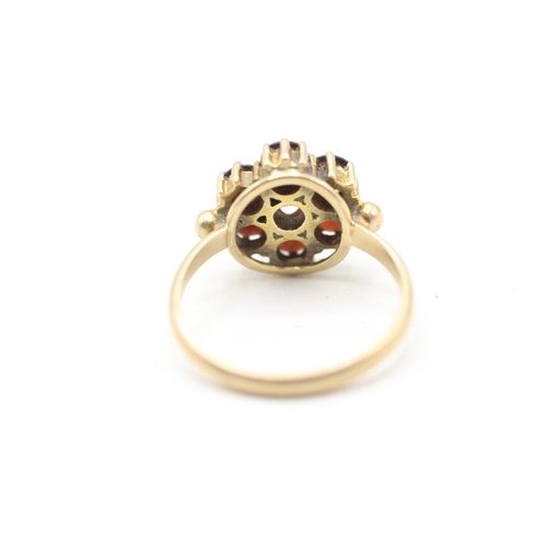 118 - 9ct gold garnet halo ring (2.9g) Size M