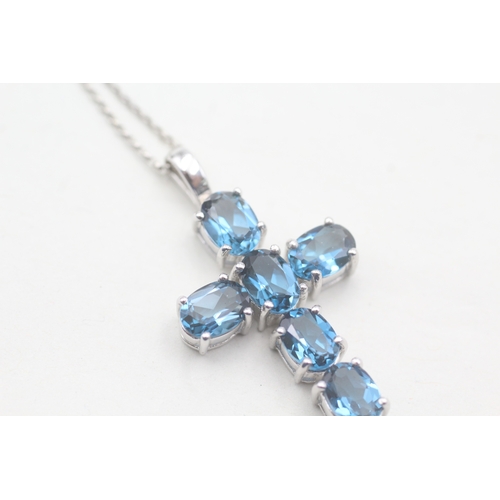 124 - 9ct gold blue topaz cross pendant on chain (5.9g)