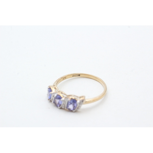 204 - 9ct gold tanzanite three stone ring with diamond accents (1.7g) Size N