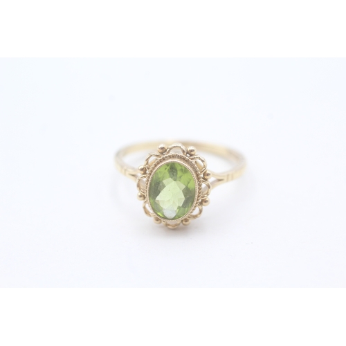 56 - 9ct gold and peridot ring (2.9g) Size P